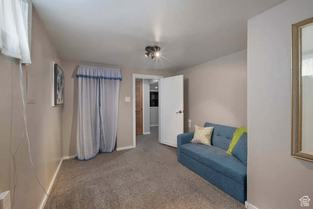 Living area with carpet flooring and baseboards