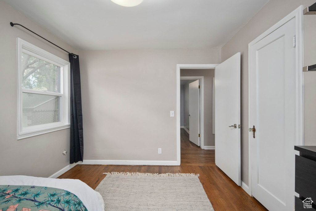 Bedroom featuring wood finished floors and baseboards