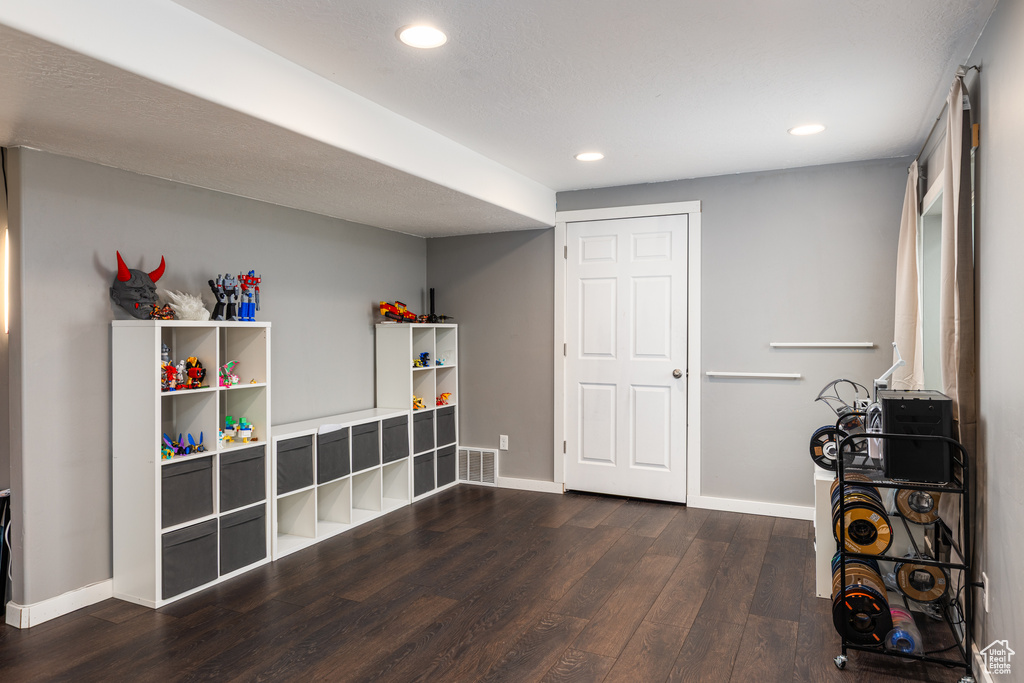 Game room with wood finished floors, recessed lighting, and baseboards