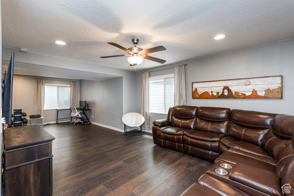Living room with hardwood / wood-style flooring, baseboards, ceiling fan, healthy amount of natural light, and recessed lighting