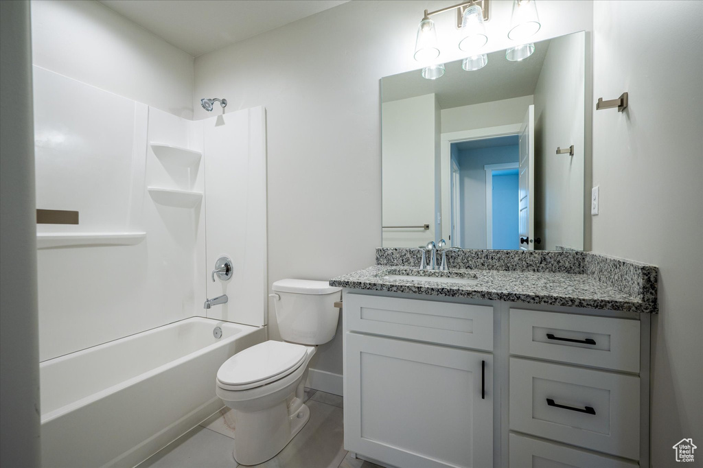 Full bathroom featuring toilet, vanity, bathing tub / shower combination, and baseboards