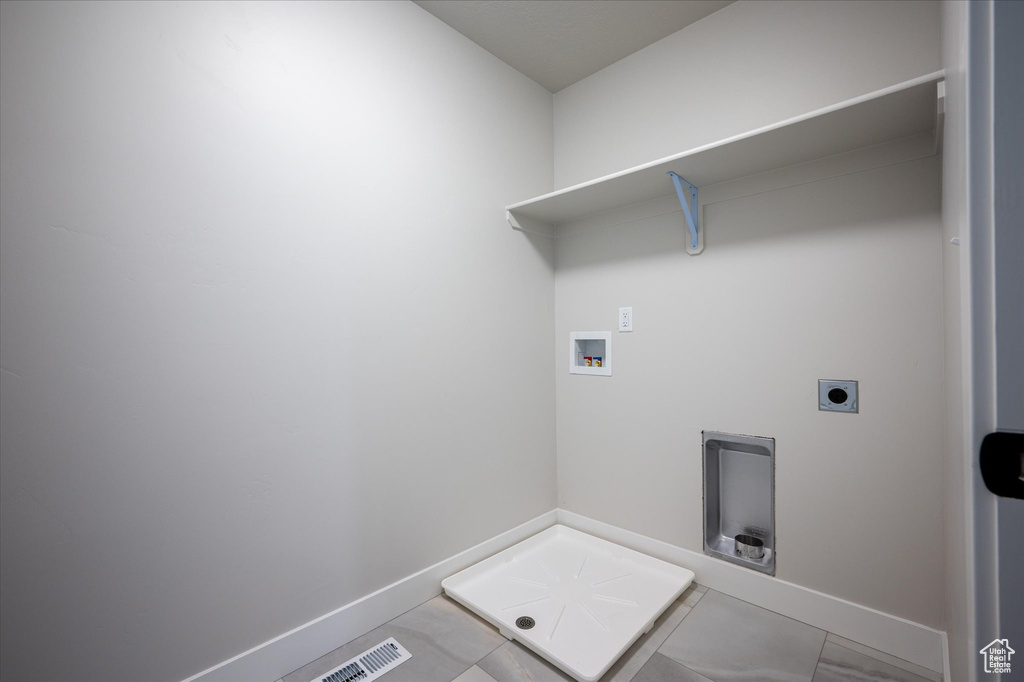 Washroom with washer hookup, baseboards, hookup for an electric dryer, and tile patterned floors