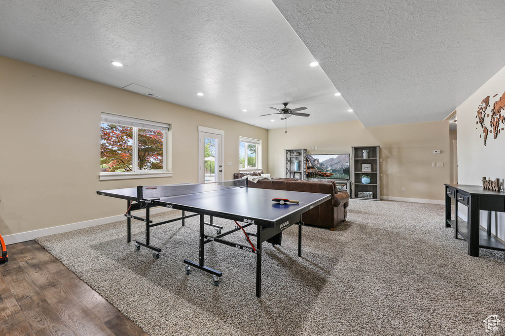 Playroom featuring a textured ceiling, ceiling fan, baseboards, recessed lighting, and wood finished floors