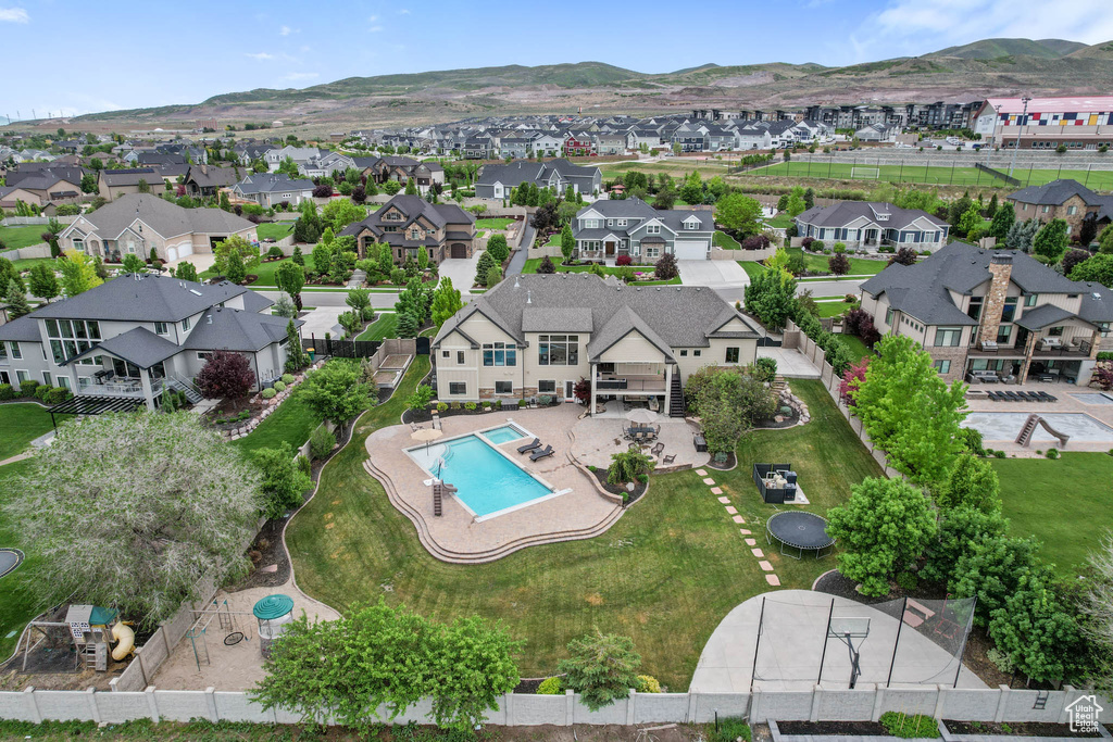 Aerial view of residential area with a pool area and mountains