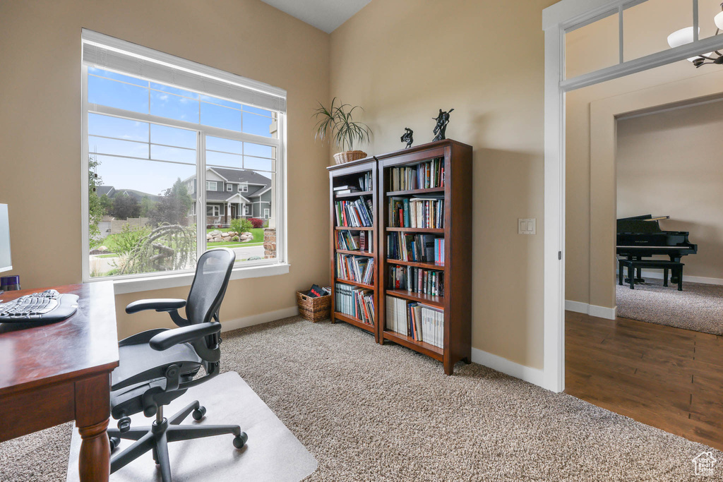 Carpeted home office with baseboards