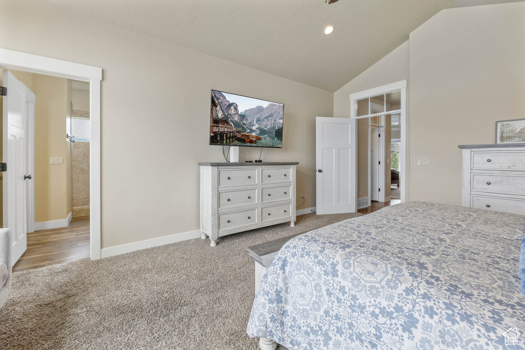 Carpeted bedroom featuring lofted ceiling, baseboards, and recessed lighting