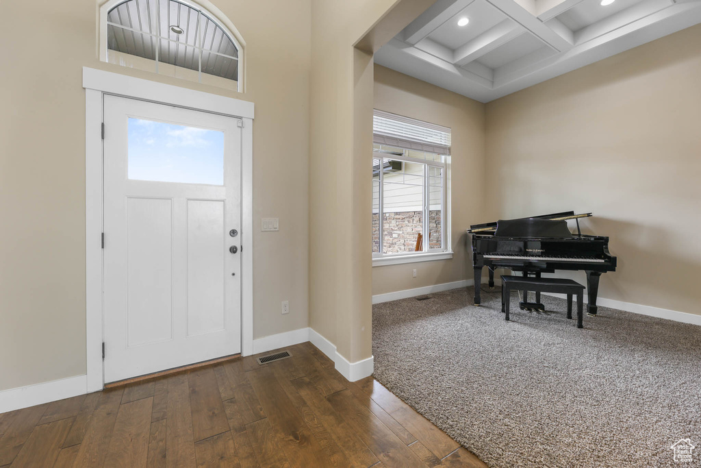 Entryway featuring coffered ceiling, beam ceiling, baseboards, dark wood-type flooring, and recessed lighting