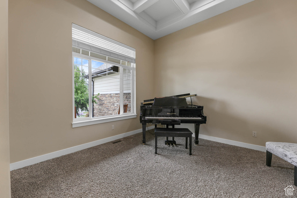 Sitting room with coffered ceiling, carpet flooring, beam ceiling, and baseboards