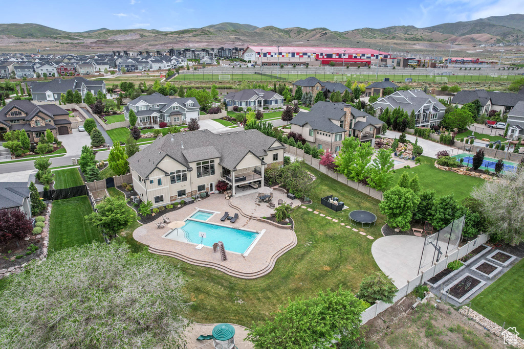 View of property location featuring nearby suburban area, a mountain backdrop, and a pool