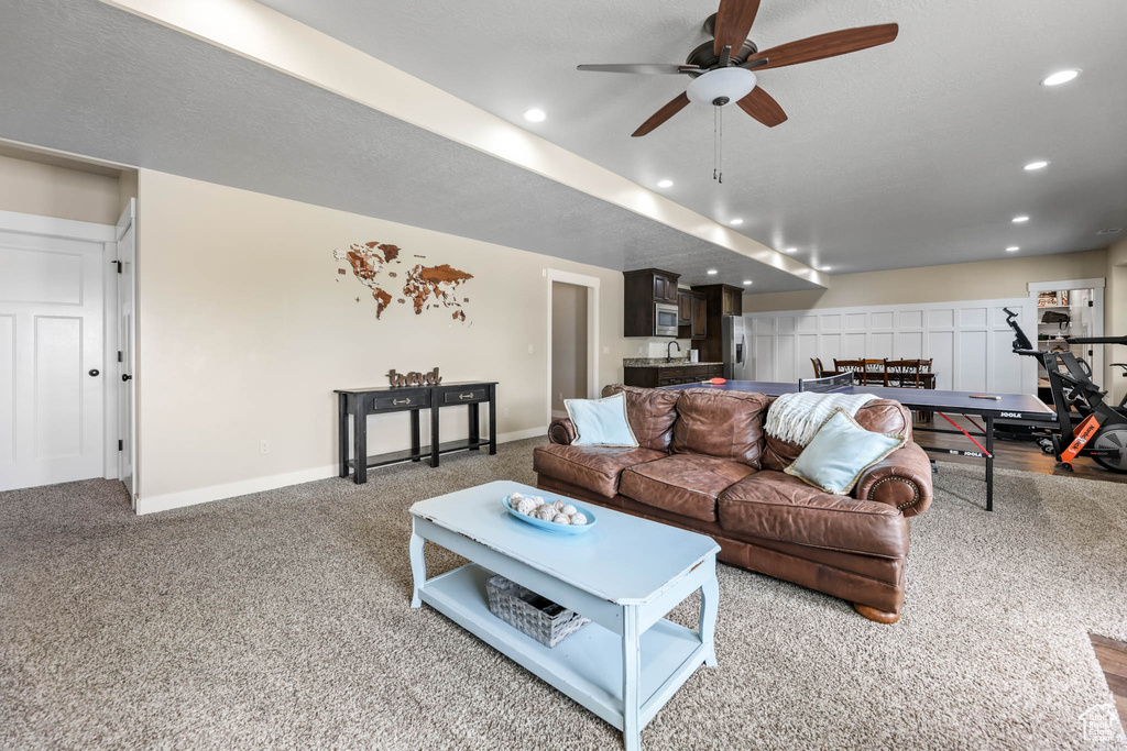 Living area featuring recessed lighting, a ceiling fan, baseboards, and carpet