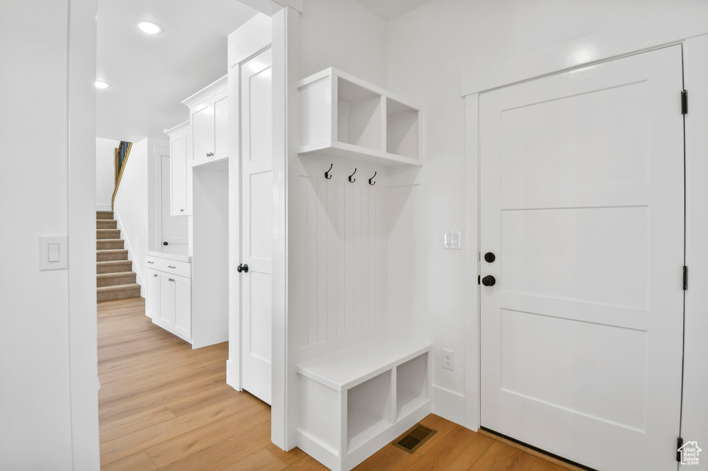 Mudroom featuring light wood-style floors