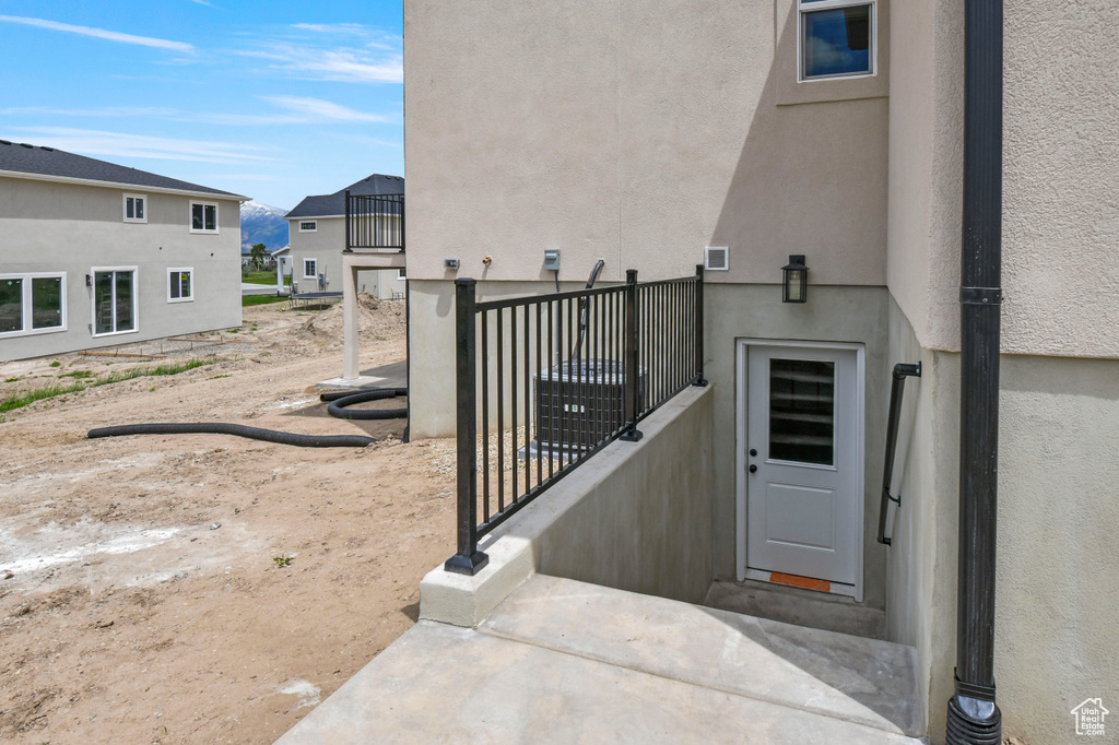 Entrance to property featuring stucco siding and a residential view