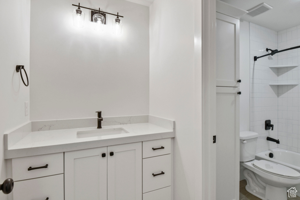 Full bathroom featuring vanity, toilet, and shower / bathtub combination
