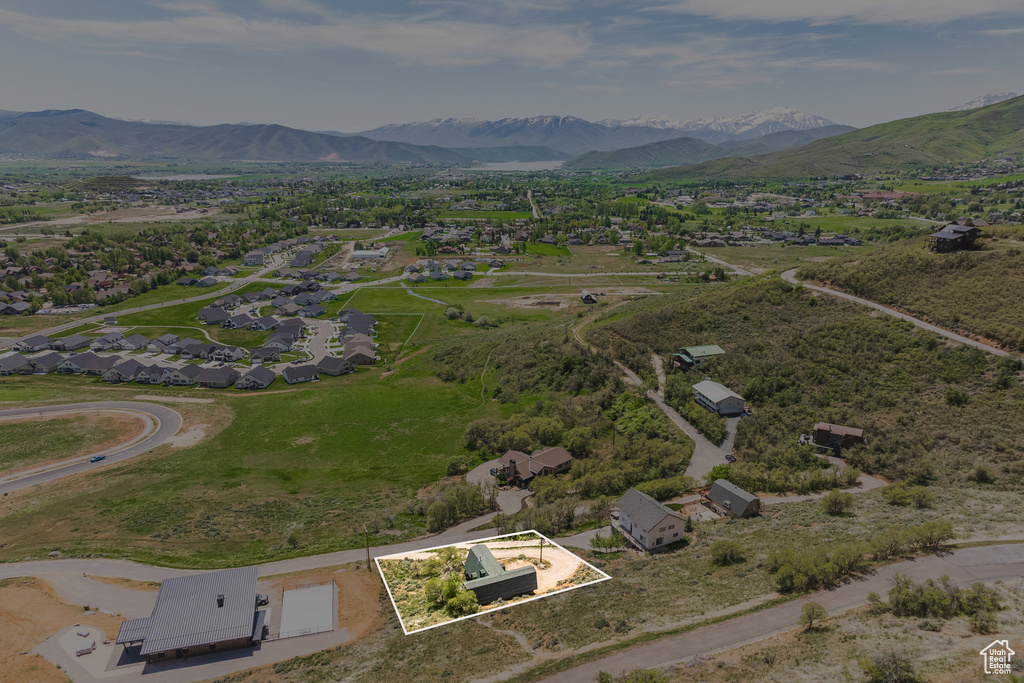 Aerial overview of property's location featuring property parcel outlined and a mountainous background