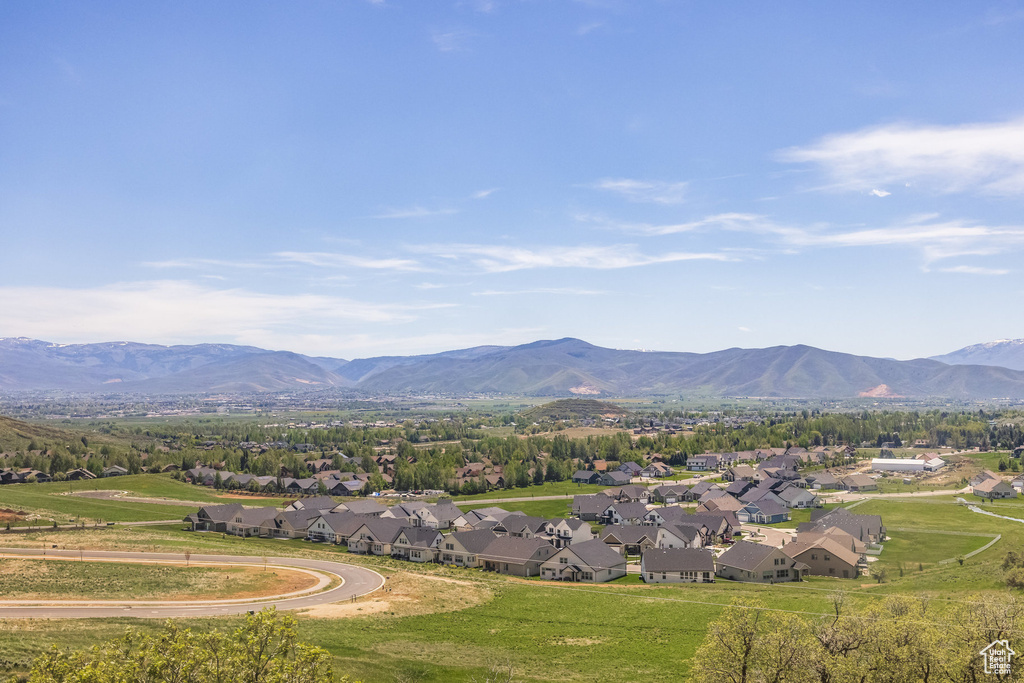 View of mountain backdrop featuring nearby suburban area