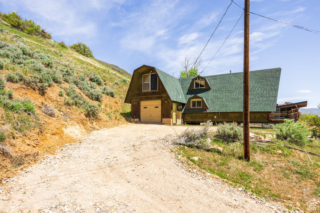 View of front of home with driveway and an attached garage