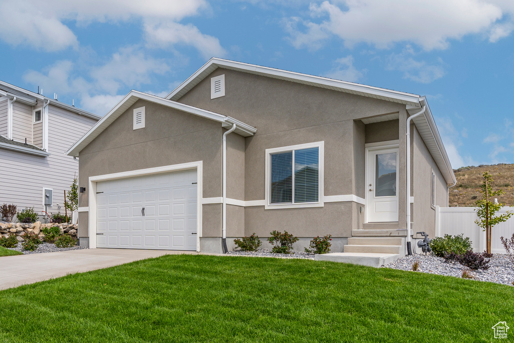 View of front of home featuring entry steps, stucco siding, driveway, and a garage