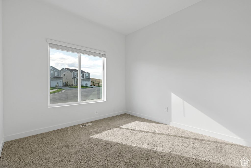 Unfurnished room featuring carpet flooring and baseboards