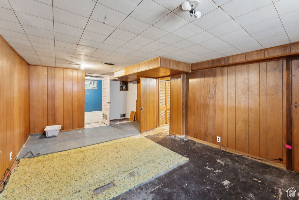 Below grade area featuring wood walls and baseboards