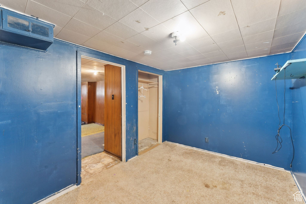 Unfurnished bedroom with carpet flooring and baseboards
