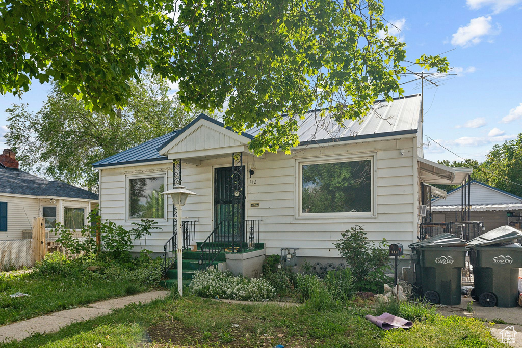 Bungalow-style house featuring metal roof and a standing seam roof