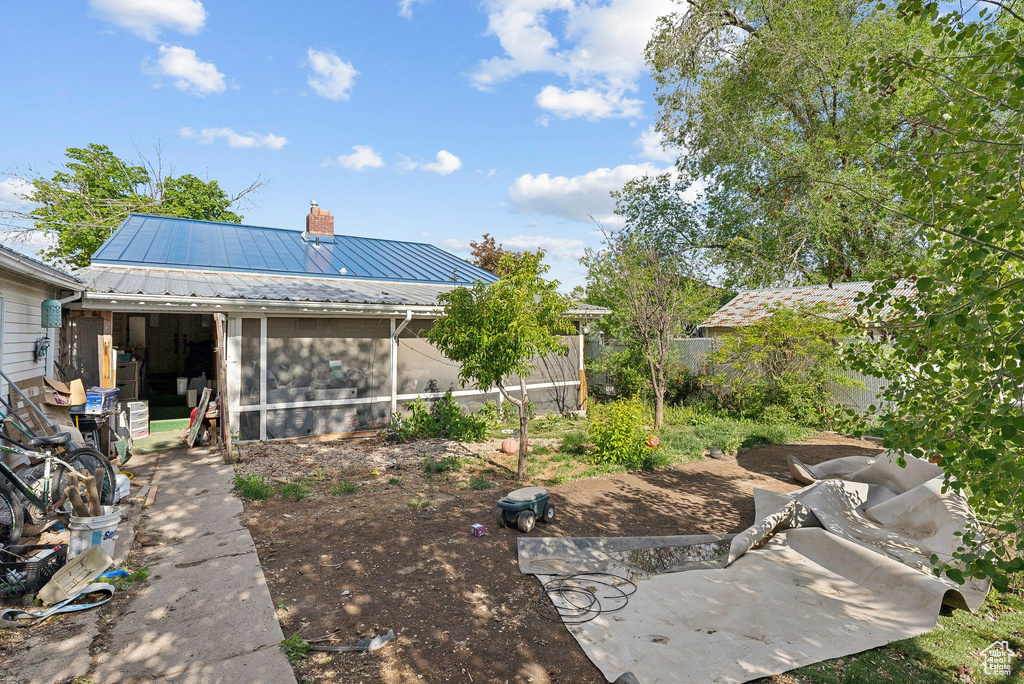 View of yard featuring a sunroom