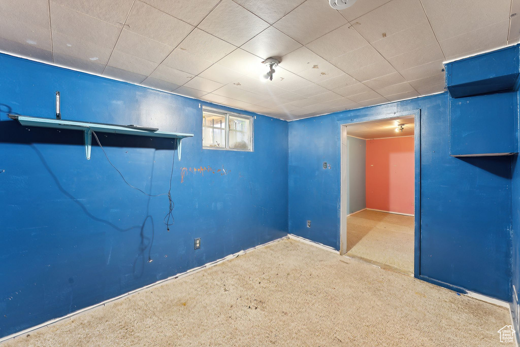 Basement featuring carpet and baseboards