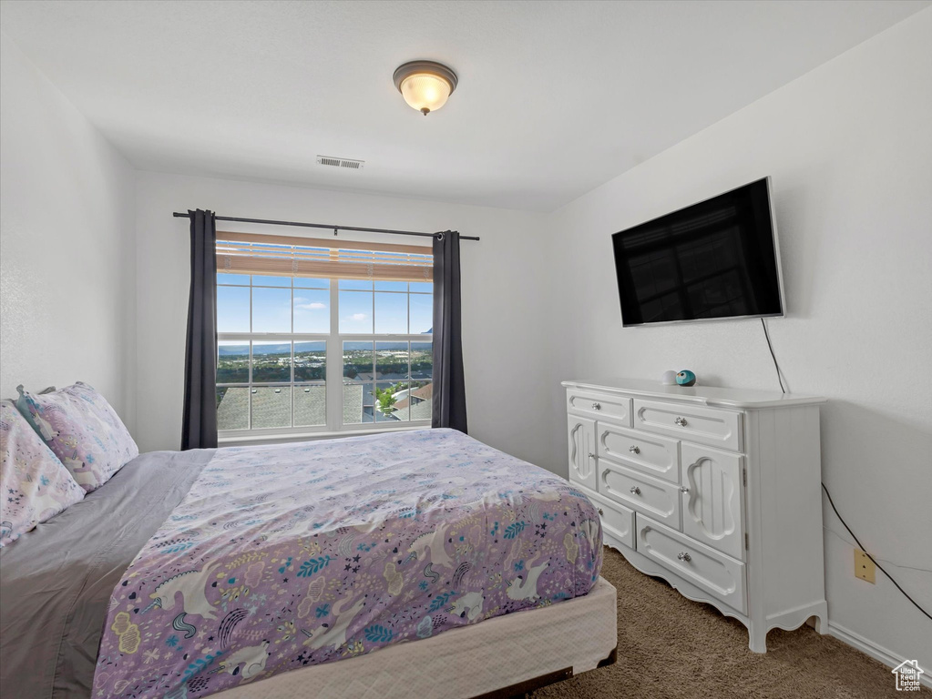 Carpeted bedroom with baseboards