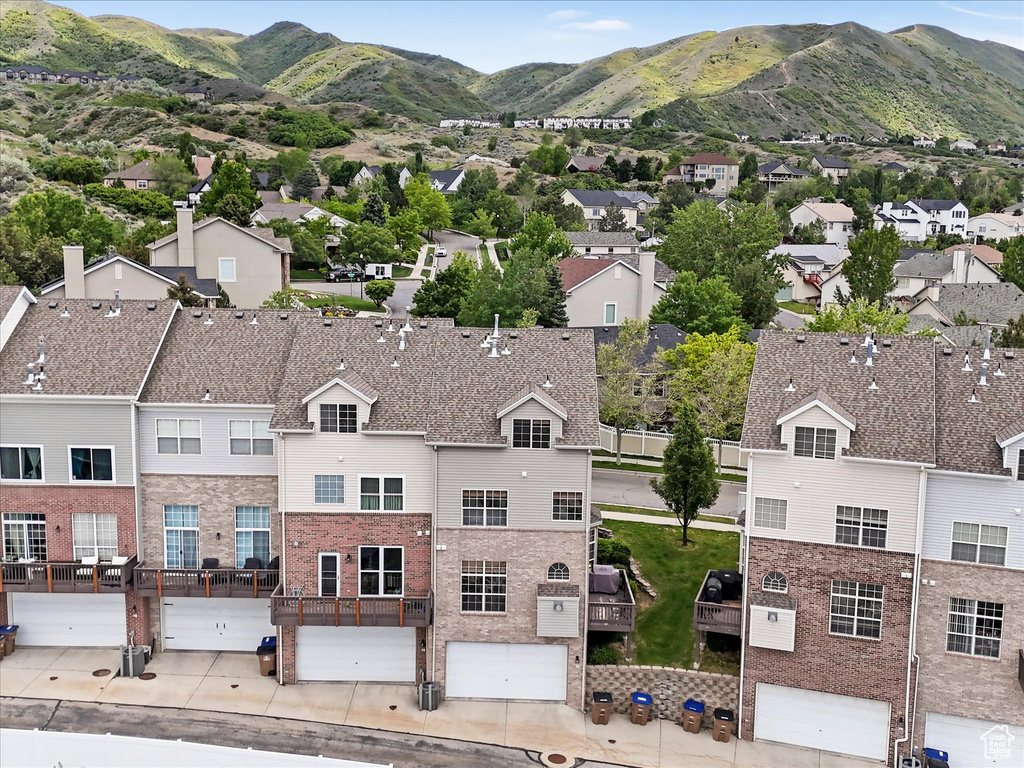 Aerial perspective of suburban area featuring a mountainous background