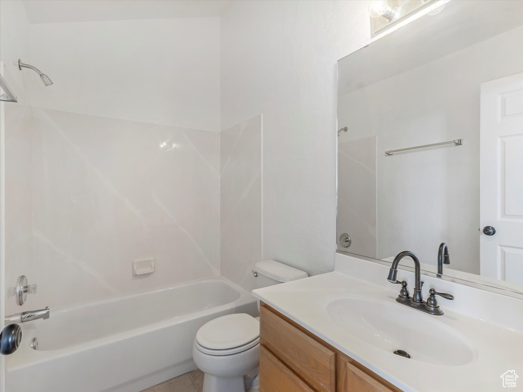 Bathroom featuring toilet, bathing tub / shower combination, and vanity