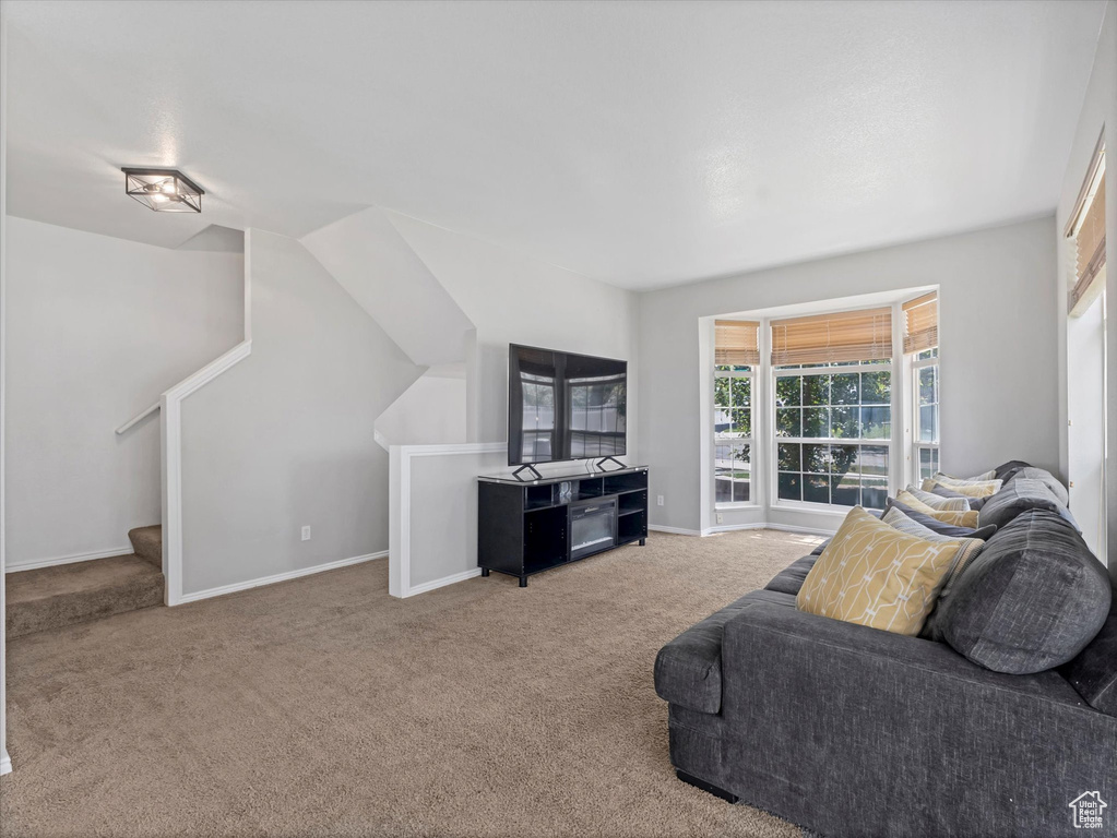 Carpeted living room with baseboards