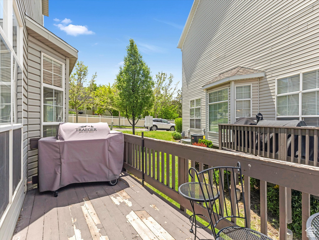 Wooden deck featuring area for grilling
