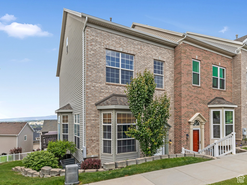 View of front of home featuring brick siding