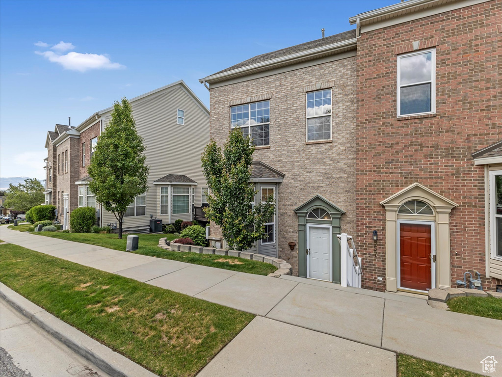 Multi unit property with brick siding and a front yard