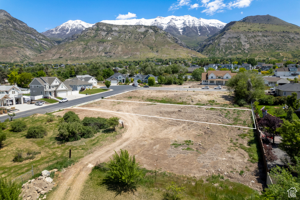 View of mountain backdrop featuring nearby suburban area