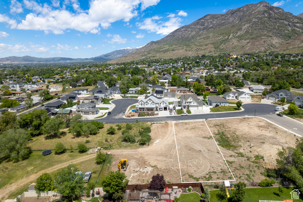 Aerial view of residential area featuring property boundaries highlighted and mountains
