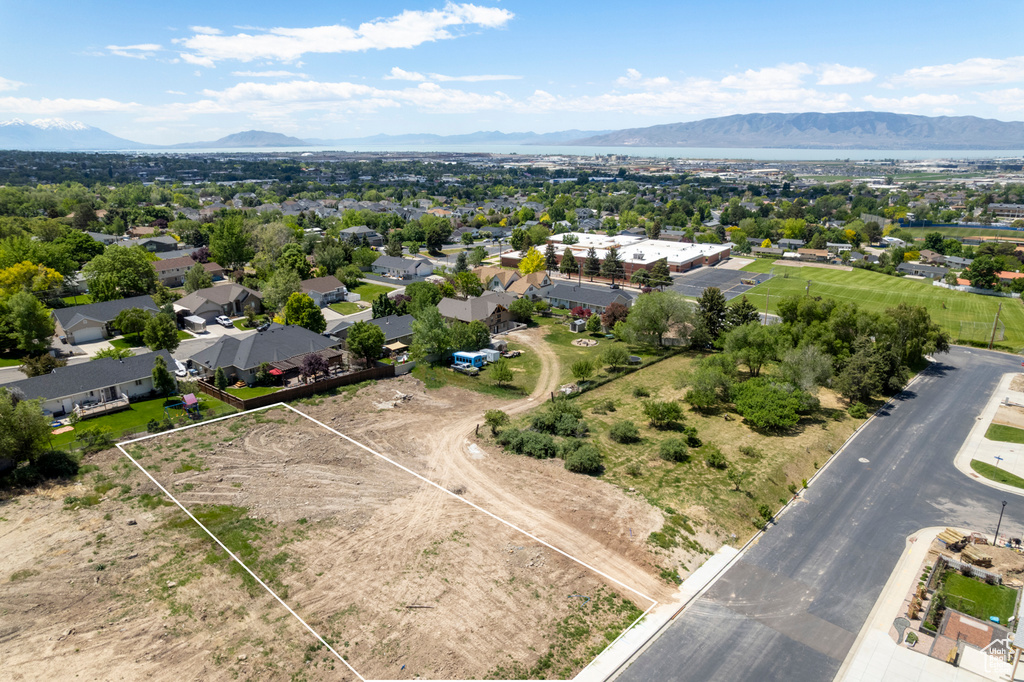 Aerial overview of property's location with a mountain backdrop and property boundaries highlighted