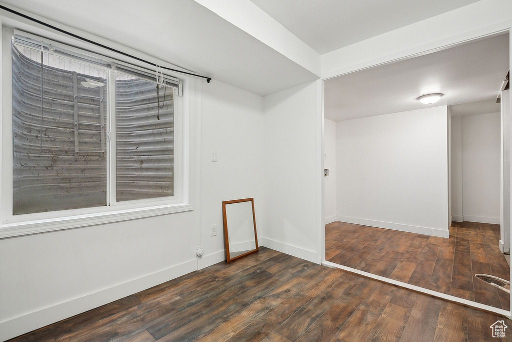 Empty room with wood-type flooring and baseboards