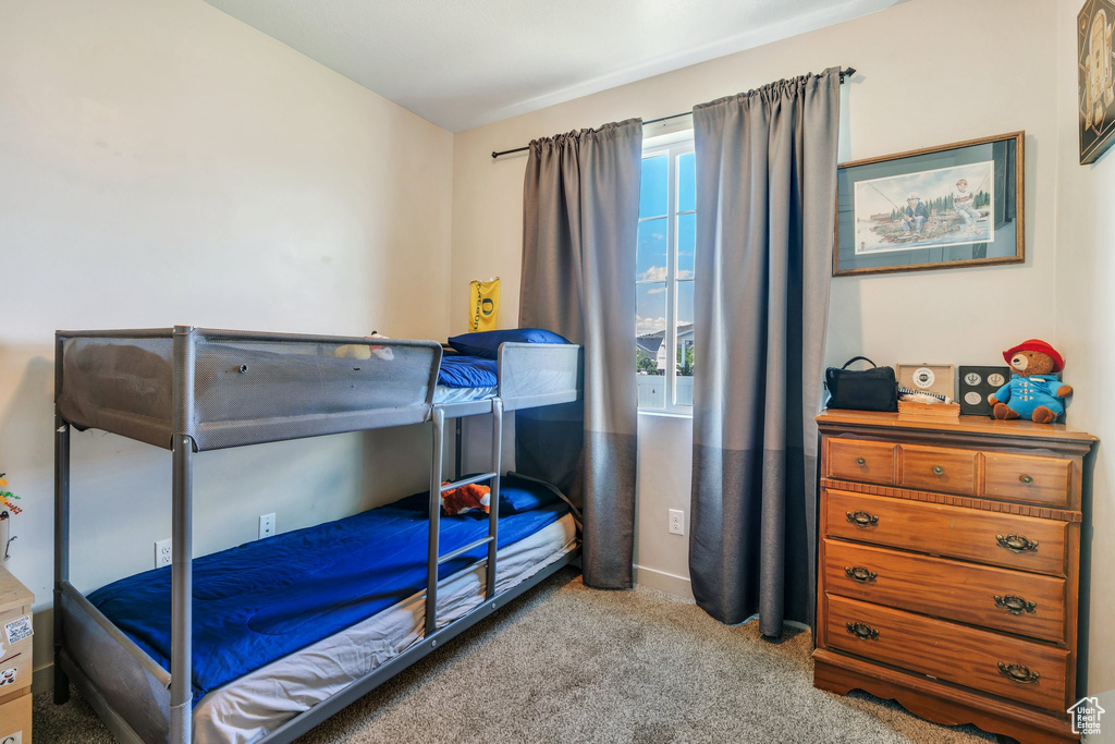 Carpeted bedroom with baseboards