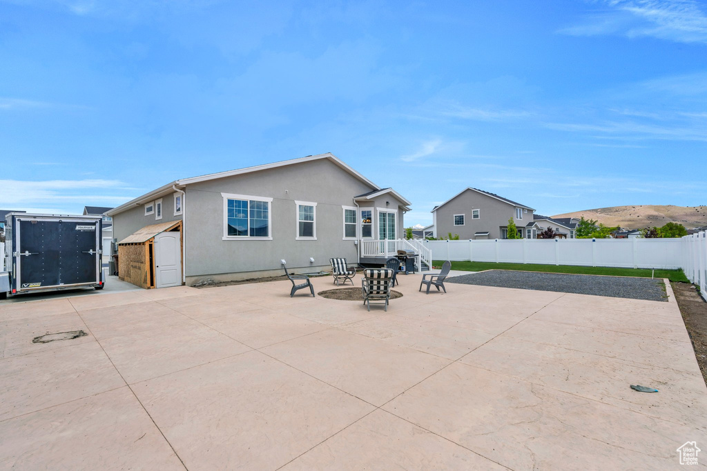 Back of property with a patio, a fenced backyard, and stucco siding