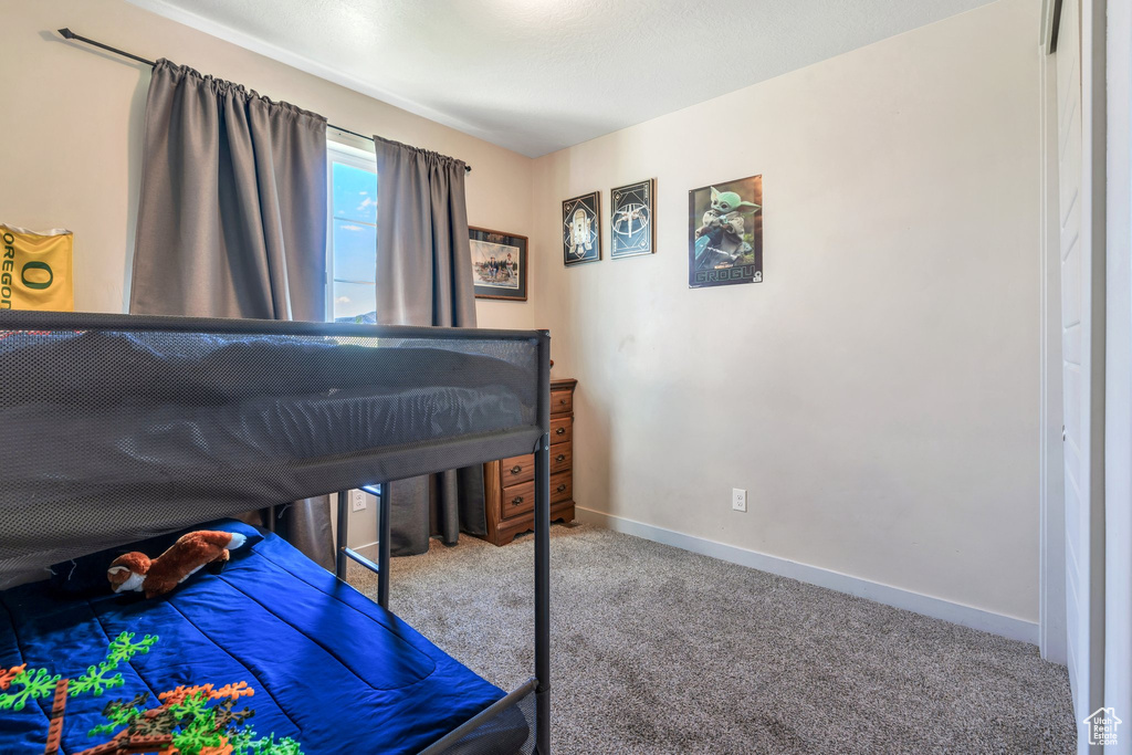 Carpeted bedroom with baseboards