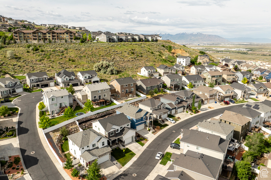 Aerial view of property's location featuring a mountainous background and nearby suburban area