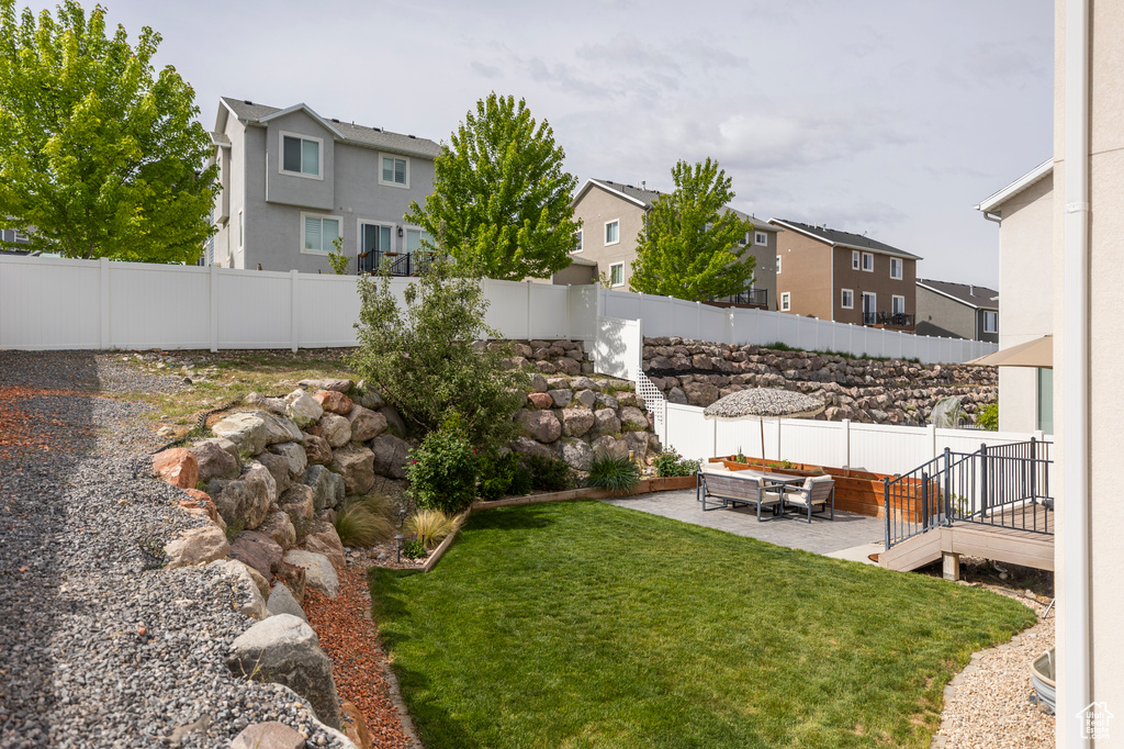 View of yard featuring a residential view, a patio, and an outdoor hangout area