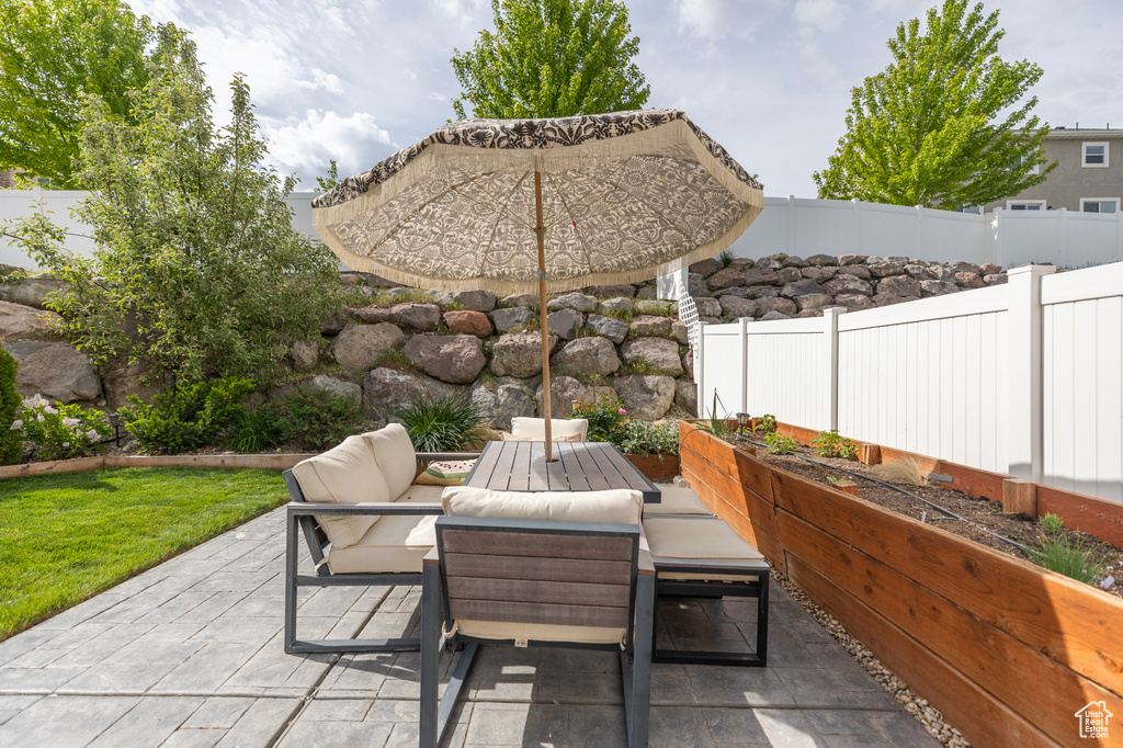 Fenced backyard with a patio and outdoor lounge area