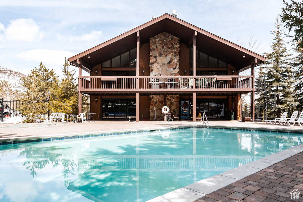 Community pool featuring a patio