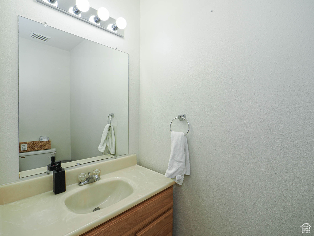 Half bathroom featuring vanity