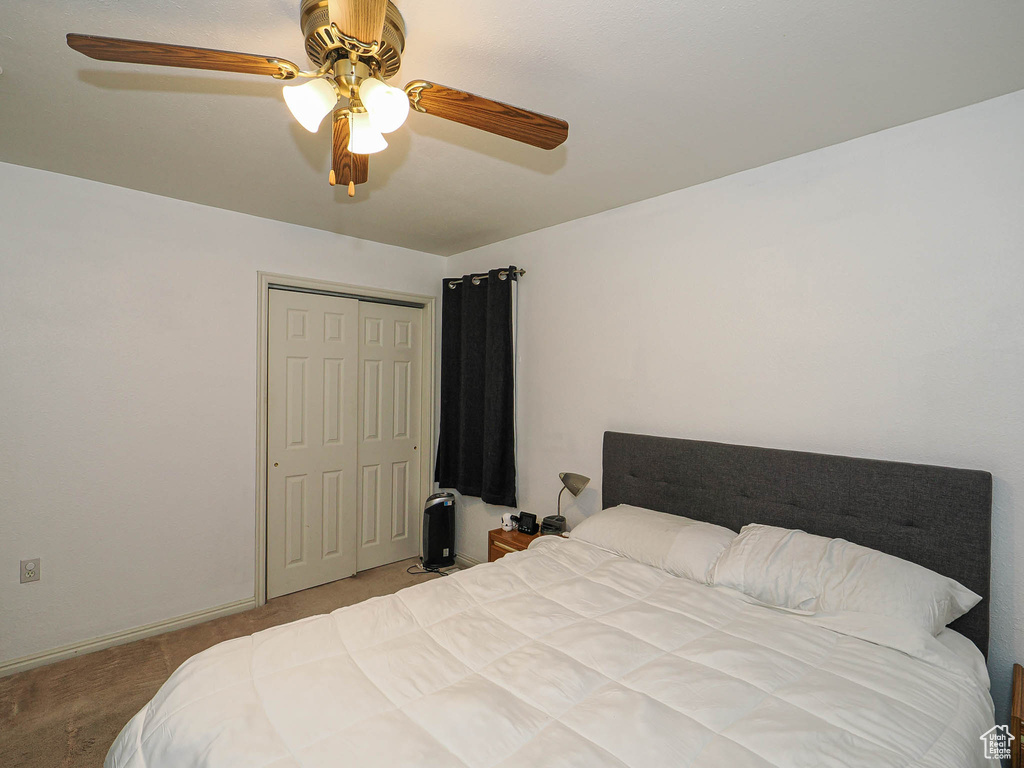 Bedroom featuring a closet, carpet floors, and a ceiling fan