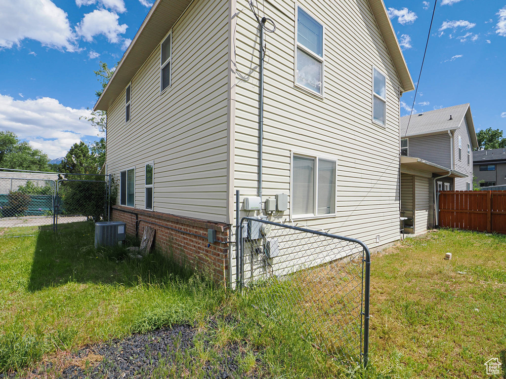 View of side of property with central air condition unit