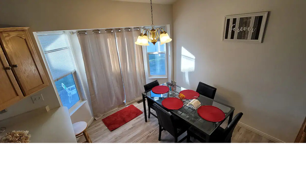 Dining room with a chandelier, light wood-style floors, and baseboards