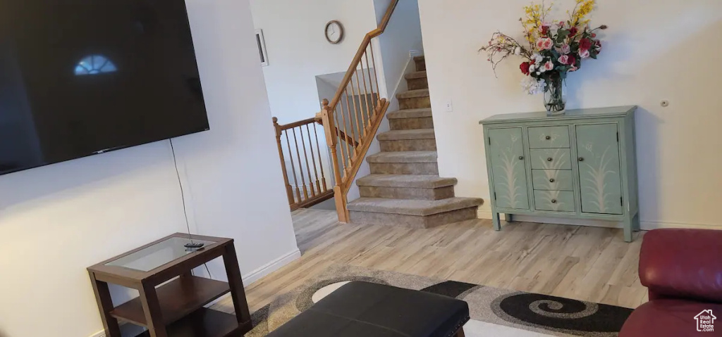 Stairs featuring wood finished floors and baseboards